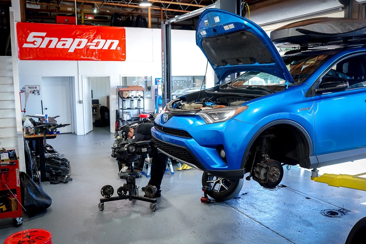 A Cen Cal tech working under the hood of a RAV4 Hybrid