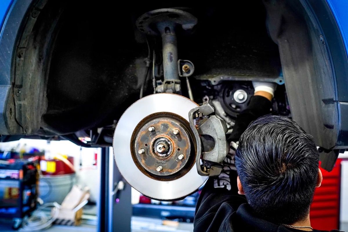 A fresh rotor and caliper going back together in the wheel well