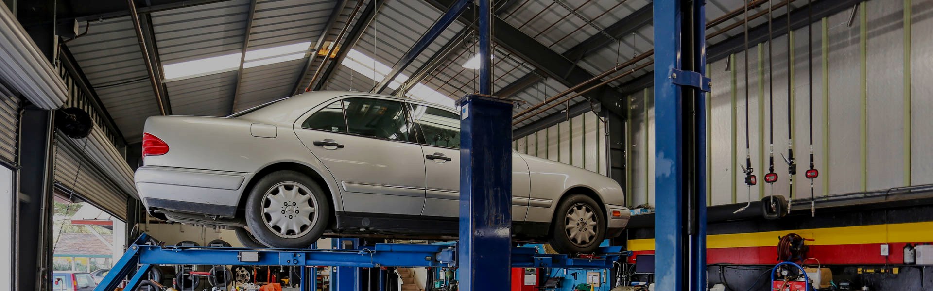 A Mercedes up on the lift in the bays