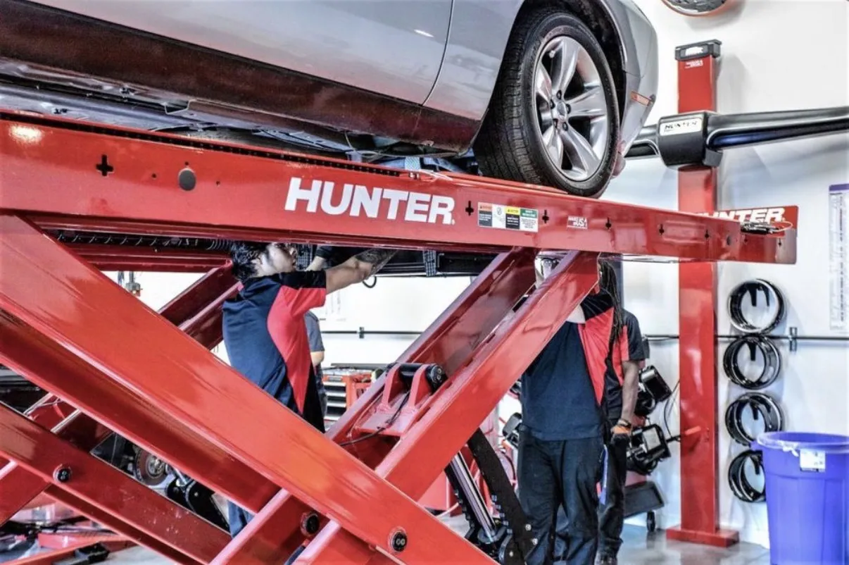 Under a car on the alignment rack