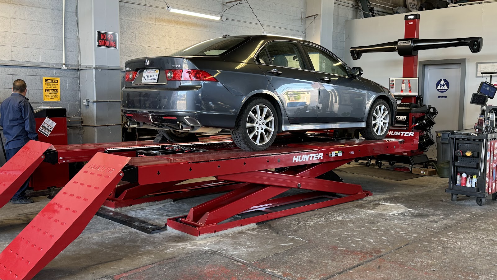 a car up on the rack in the bay