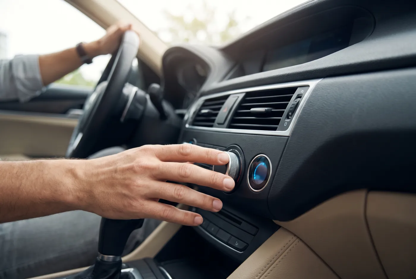 adjusting the A/C climate controls in a car
